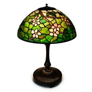 Tiffany Studios leaded glass table lamp with Apple Blossom shade pattern and bronze tree trunk base