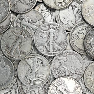 Pile of circulated Walking Liberty Half Dollars in 90% silver showing striding Liberty obverses and eagle reverses