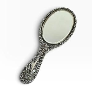 Sterling silver hand mirror with repousse floral and scroll decoration on the handle and frame, beveled oval glass